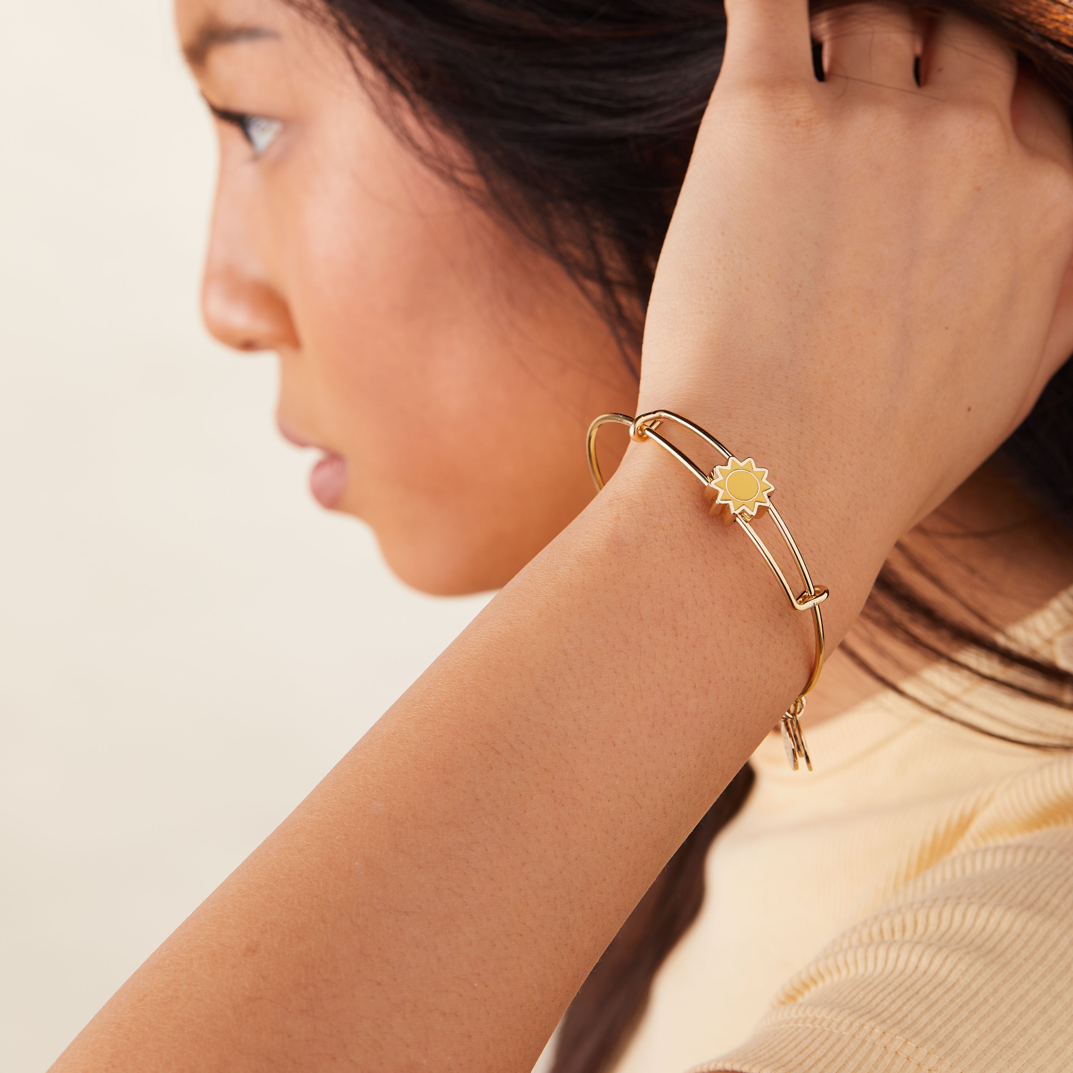 sun-motif-inline-charm-bangle-model-AA647722EWBSG.jpg